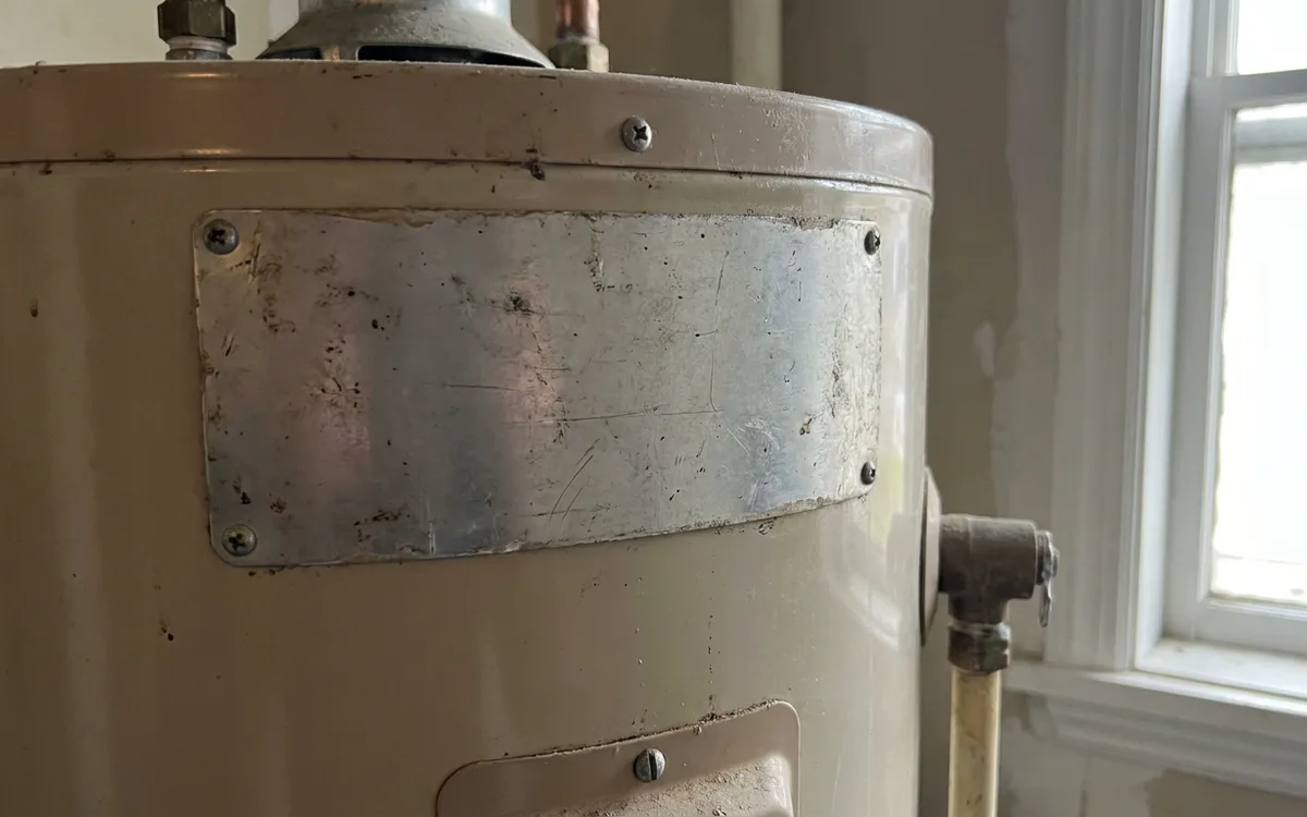 Blank manufacturer rating plate on the side of a residential water heater