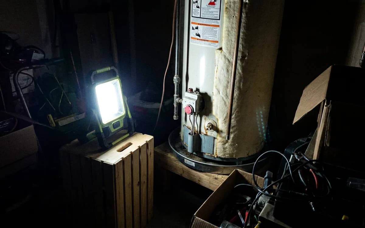 Work light illuminating a water heater in a dim garage