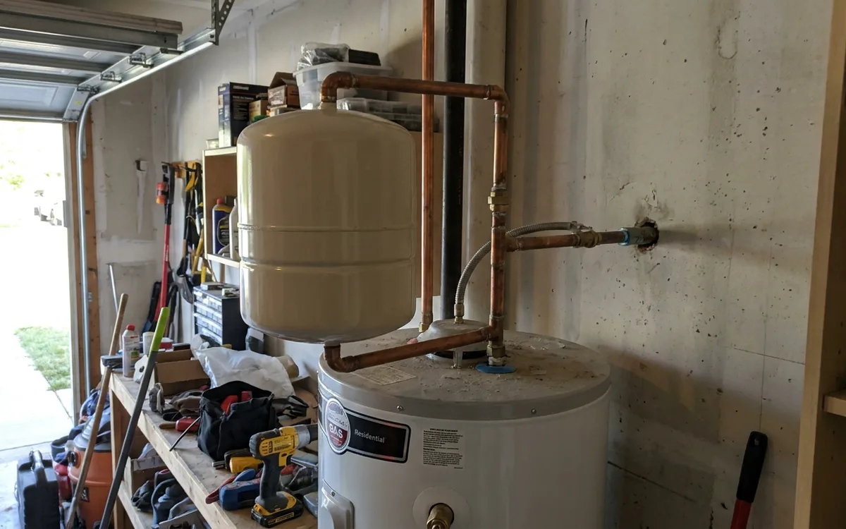 Thermal expansion tank mounted on the cold water line above a water heater