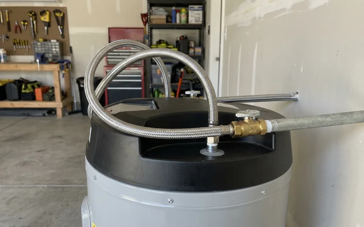 Tidy water heater installation with braided connectors in a garage