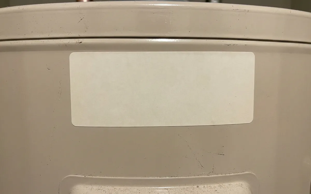 Blank serial and rating label on the upper shell of a water heater