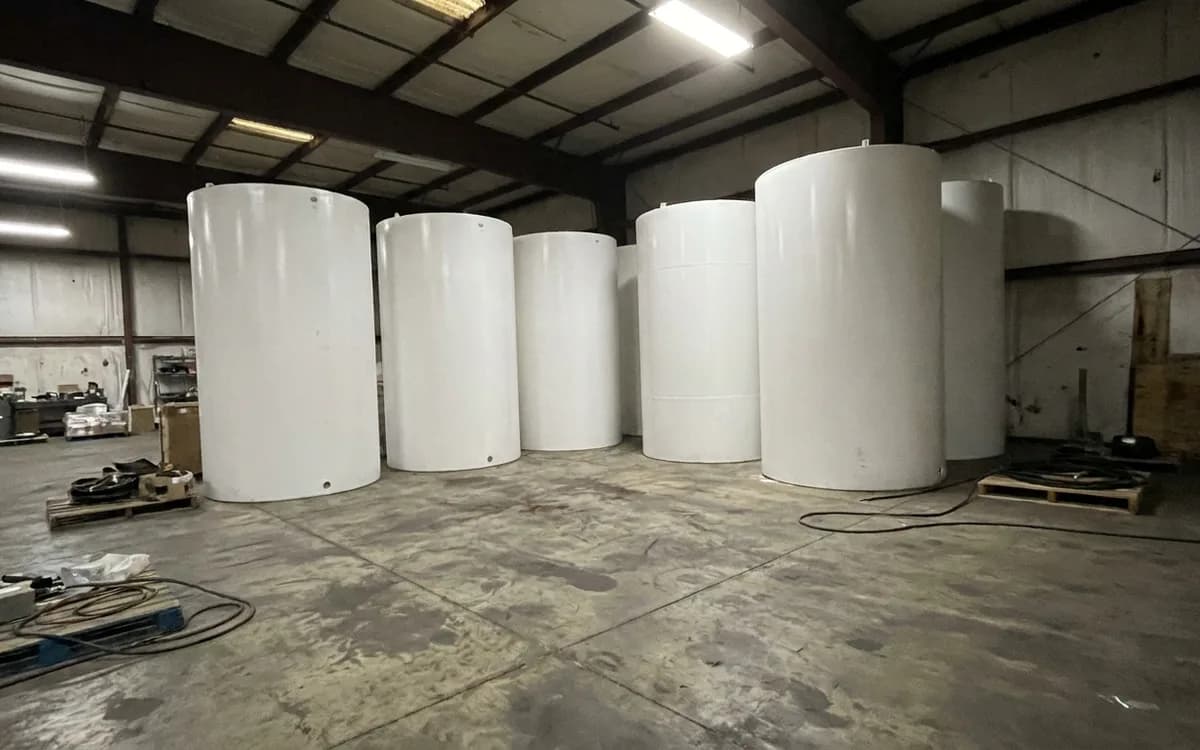 Row of new residential water heaters on a supply house floor