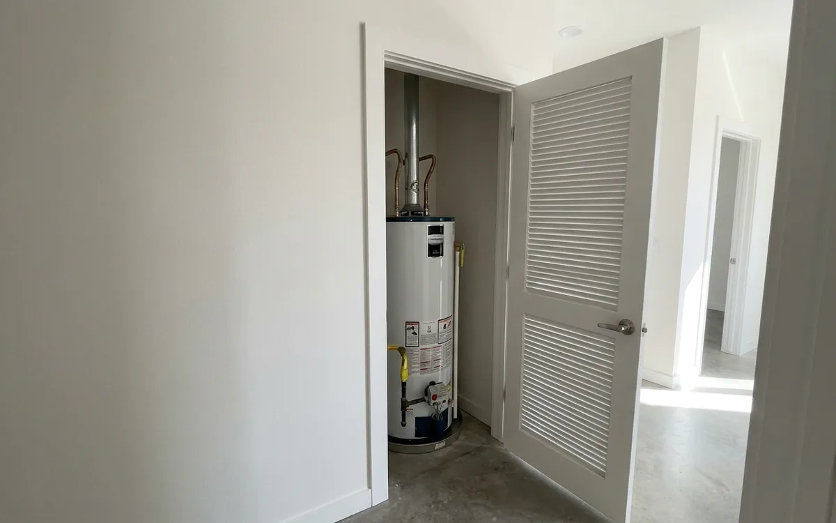 Water heater in a purpose-built utility closet in a newer home