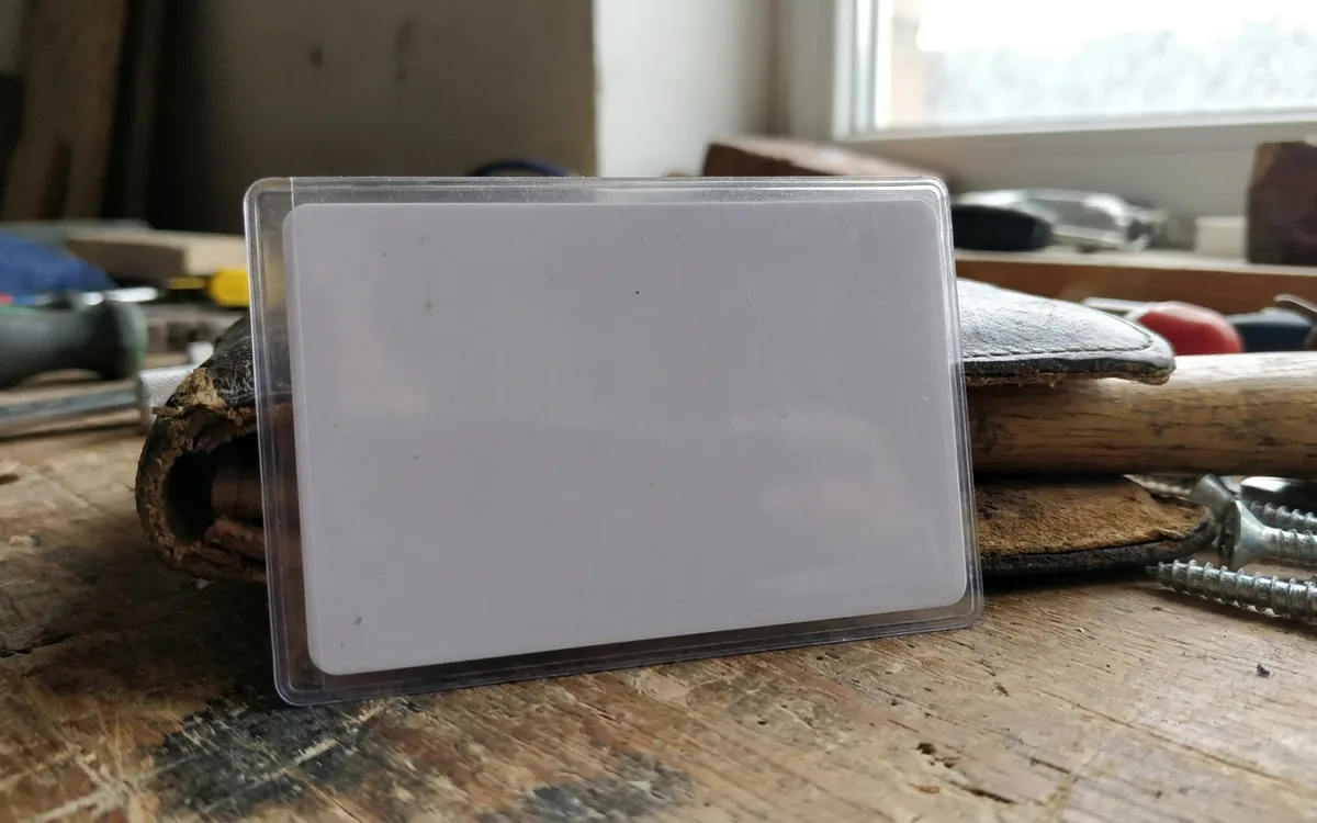 Blank identification card in a wallet sleeve on a workbench