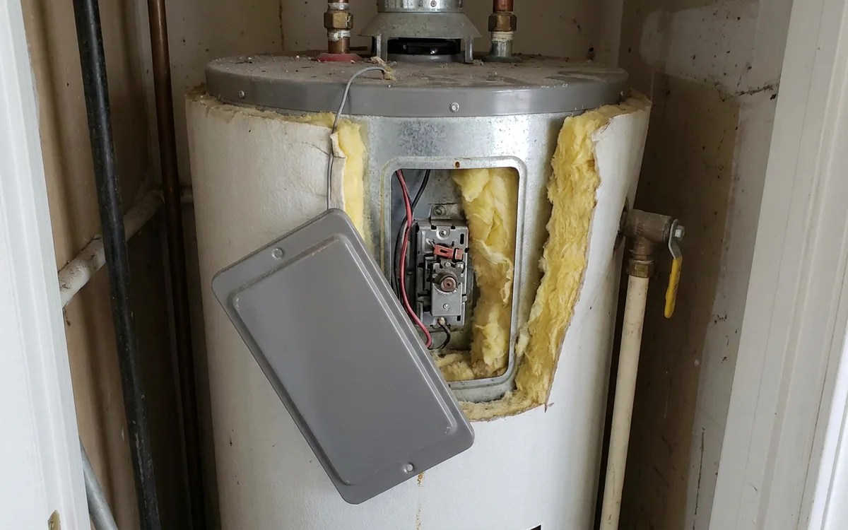 Rating plate area of a residential tank water heater with the access panel visible
