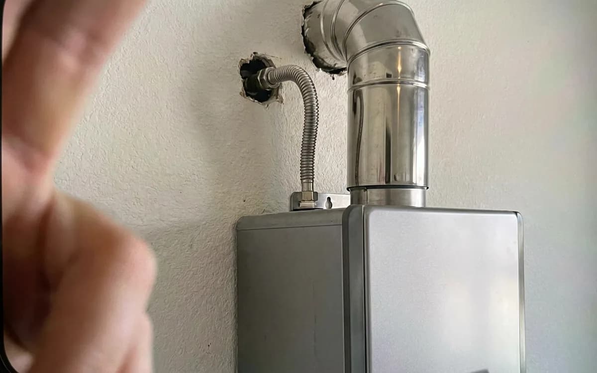Gas line and stainless vent penetration behind a newly mounted tankless heater